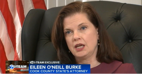 Judge Eileen Burke speaks to a journalist in her office. 